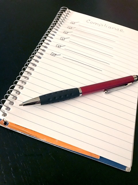 Pen and notebook with compliance checkboxes